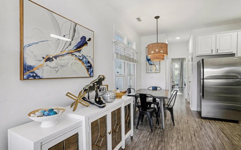 Open dining area steps from the kitchen — seats the family with coastal art all around