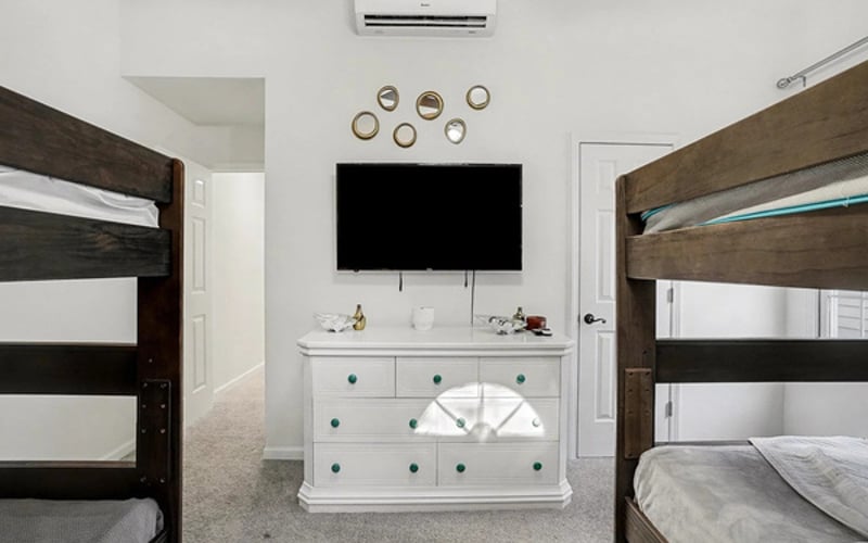 The bunk room has its own AC, smart TV, and dresser — teen approved