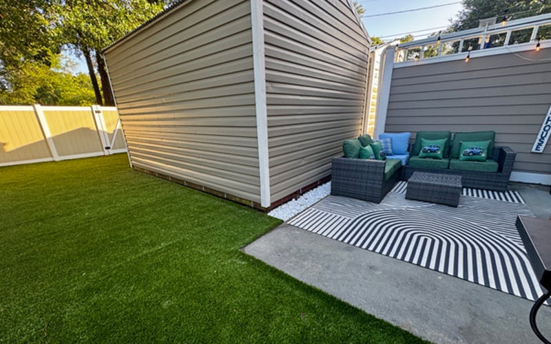 Low-maintenance private turf yard — room to play, lounge, and rinse off after the beach